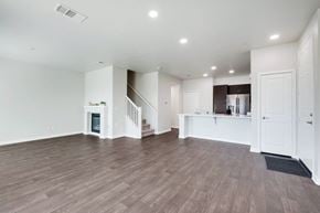 Chula Vista apartment for rent - A spacious living room with wood flooring and a staircase leading to the upper level.