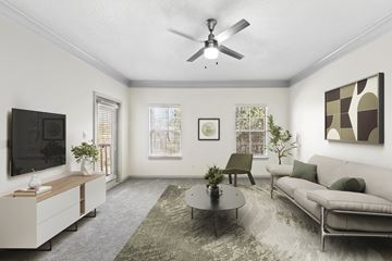 Mcdonough apartment for rent - A living room with a grey couch, a coffee table, a television, and a painting on the wall.