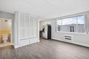 Nashville apartment for rent - A room with a toilet, a cabinet, and a window.