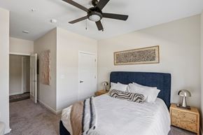 Jackson apartment for rent - A bedroom with a large bed and a ceiling fan.