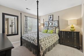 Chapel Hill apartment for rent - A bedroom with a four poster bed and a dresser.