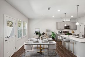 Morrisville townhouse for rent - Open kitchen and dining room with a table and chairs inside a townhome at Porchlight Brier Creek