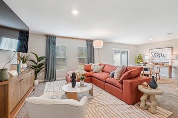 Jacksonville apartment for rent - A living room with a red couch and a white chair.