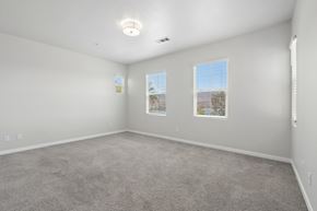 Chula Vista apartment for rent - A spacious room with carpeted floor and two windows.
