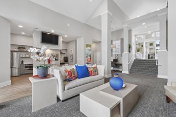 Chapel Hill apartment for rent - A modern living room with a white couch and a television mounted on the wall.