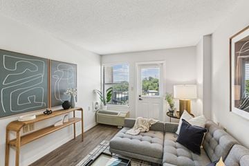 Madison apartment for rent - A living room with a grey sofa and a wooden bench.
