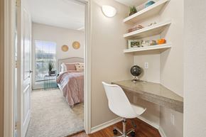 San Antonio apartment for rent - a bedroom with a bed and a desk with a chair