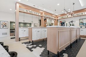 Frisco apartment for rent - A modern kitchen with a long wooden island and black and white tiled flooring.