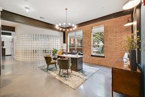 Dallas apartment for rent - A room with a brick wall and a table with chairs.