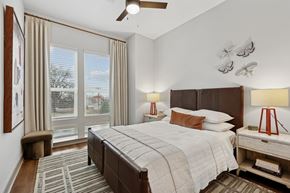 Nashville apartment for rent - A bedroom with a large bed and a ceiling fan.