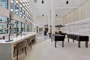 Huntsville apartment for rent - A modern interior with a long bar and pool tables.