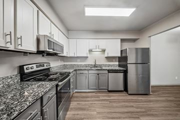 Indianapolis apartment for rent - A kitchen with granite countertops and stainless steel appliances.