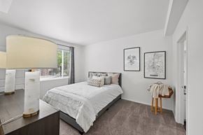 Littleton apartment for rent - A bedroom with a large bed and two framed pictures on the wall.