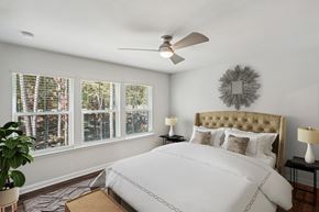 Morrisville townhouse for rent - Bedroom with white walls and a ceiling fan inside a home at Porchlight Brier Creek