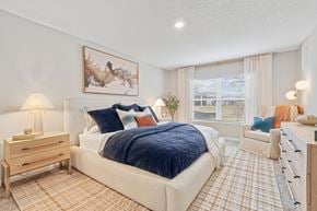 Jacksonville apartment for rent - A bedroom with a large bed and a painting on the wall.