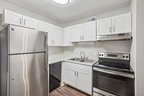 Nashville apartment for rent - A kitchen with a stainless steel refrigerator, oven, and cabinets.
