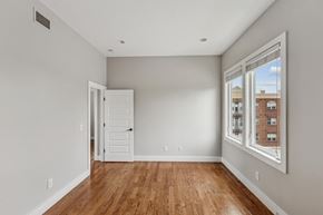 Nashville apartment for rent - A room with a wooden floor and a window showing a building outside.