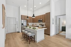 Huntsville apartment for rent - A kitchen with wooden cabinets and a white island.