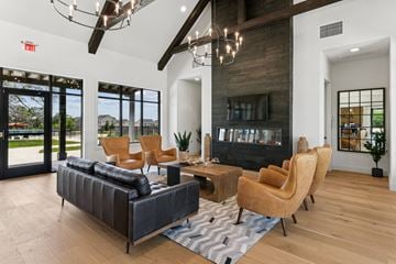 San Antonio apartment for rent - A living room with a black couch and a fireplace.