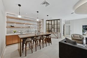 Huntsville apartment for rent - A modern kitchen with a long table and chairs.