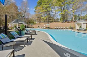 Raleigh apartment for rent - A pool surrounded by trees and a gazebo.