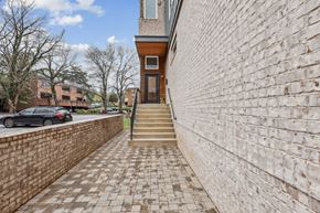Nashville apartment for rent - A brick wall with a staircase leading to a door.