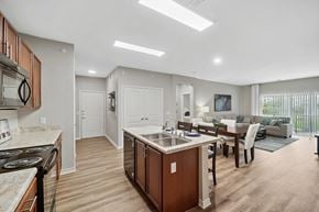 Brighton apartment for rent - A modern kitchen with wooden cabinets and a central island.