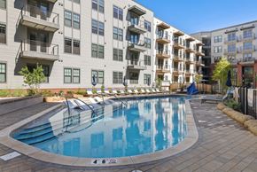 Huntsville apartment for rent - A swimming pool in front of apartment buildings.