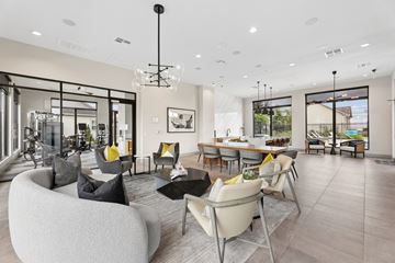 Bastrop apartment for rent - A modern living room with a large white sofa and a black chandelier.