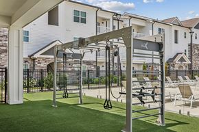 Nashville apartment for rent - A gym with a pull up bar and a bench outside a building.