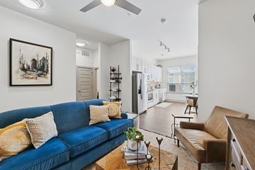 Charlotte apartment for rent - A living room with a blue couch and a painting on the wall.