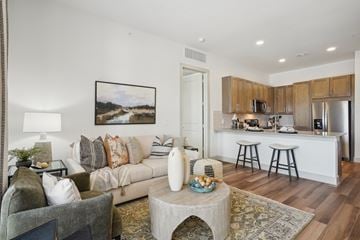 Plano apartment for rent - A living room with a grey couch and a coffee table in front of it.