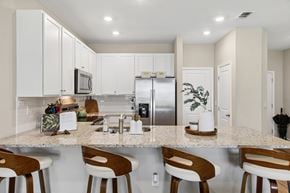 Jacksonville apartment for rent - A kitchen with white cabinets and a granite countertop.