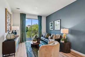 Cedar Park apartment for rent - A living room with a couch, chair, and a table with a vase on it.