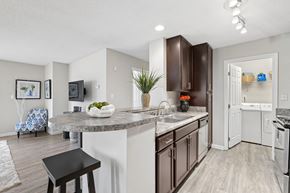 Cary apartment for rent - A kitchen with a white counter top and brown cabinets.