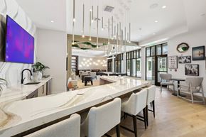Wesley Chapel apartment for rent - a large kitchen with a marble counter top and chairs
