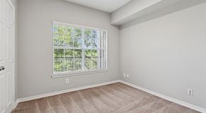 Grand Prairie apartment for rent - A room with a window covered in blinds and carpet on the floor.