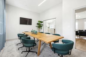 Fort Myers apartment for rent - a conference room with a wooden table and blue chairs