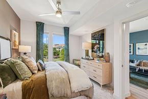Cedar Park apartment for rent - A bedroom with a large bed and a ceiling fan.