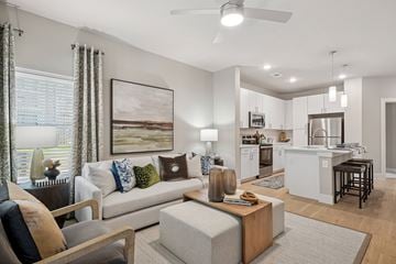 Sherman apartment for rent - A modern living room with a grey couch and a wooden coffee table.