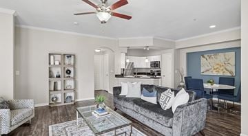 Dallas apartment for rent - A living room with a grey couch and a ceiling fan.