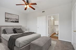 Arlington apartment for rent - a bedroom with a large bed and a ceiling fan