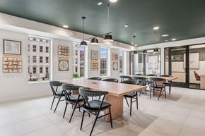 Frisco apartment for rent - A modern dining room with a long table and chairs.