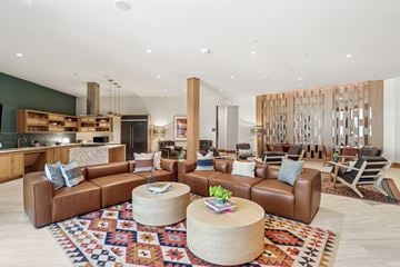 Carrollton apartment for rent - A living room with a brown leather couch and a wooden coffee table.