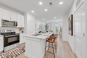 Acworth apartment for rent - a large kitchen with white cabinets and a white counter top