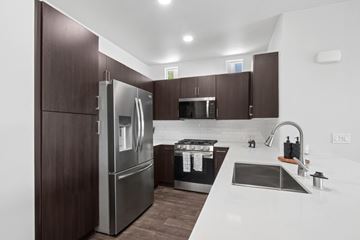 Chula Vista apartment for rent - A modern kitchen with dark wood cabinets and stainless steel appliances.