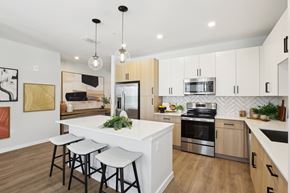 Wesley Chapel apartment for rent - an open kitchen with a large island with three stools