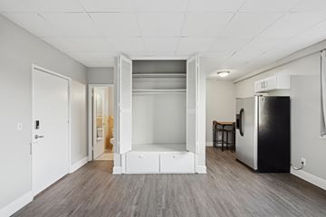 Nashville apartment for rent - A kitchen with a refrigerator and a bar stool.