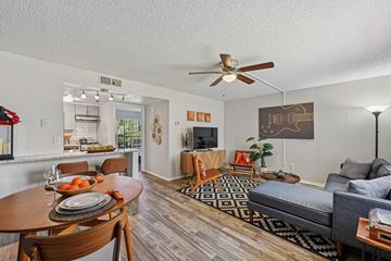 Palm Bay apartment for rent - A living room with a grey couch and a wooden table.