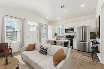 Gainesville apartment for rent - A modern living room with a white couch and a wooden coffee table.